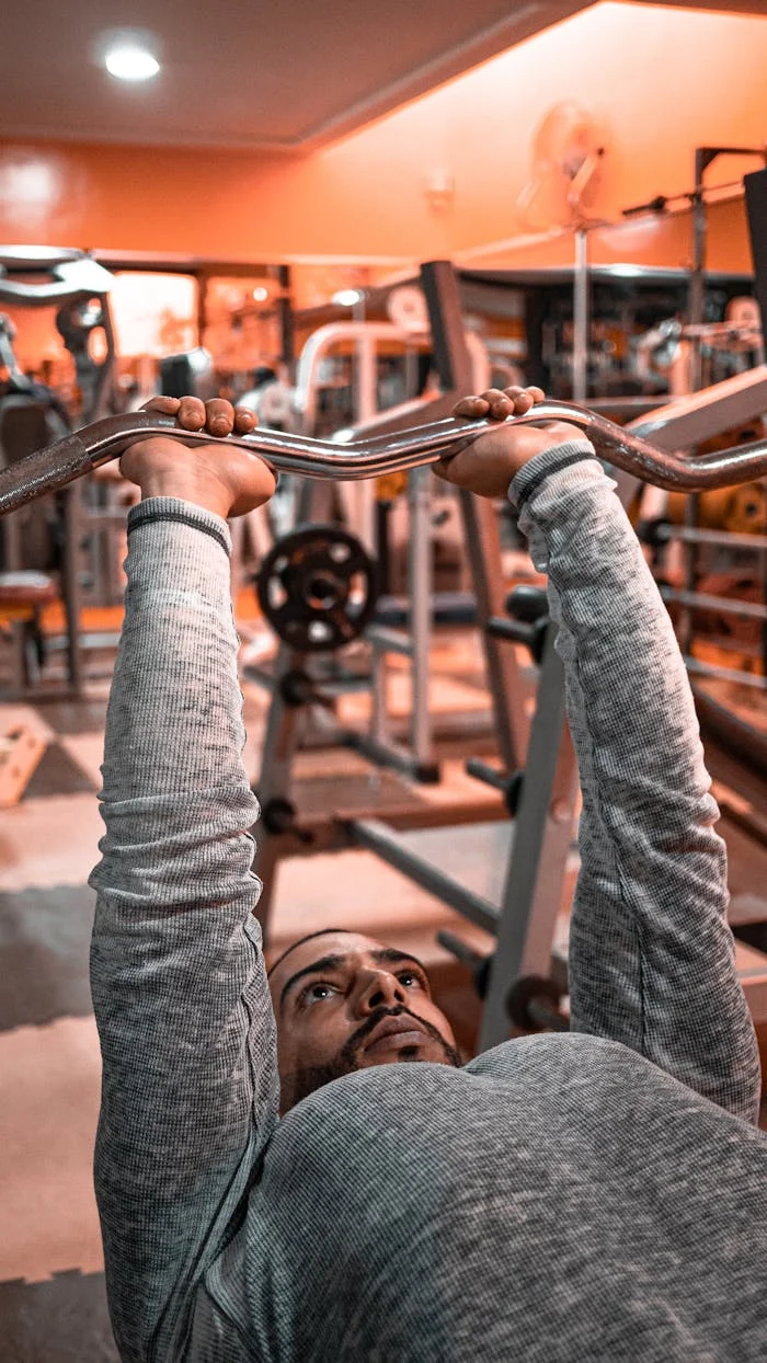 Crafting Captivating Headlines: Your awesome post title goes here Man engaged in weightlifting exercise in a Moroccan gym setting.